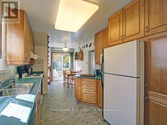 A kitchen with wooden cabinets and a white refrigerator.