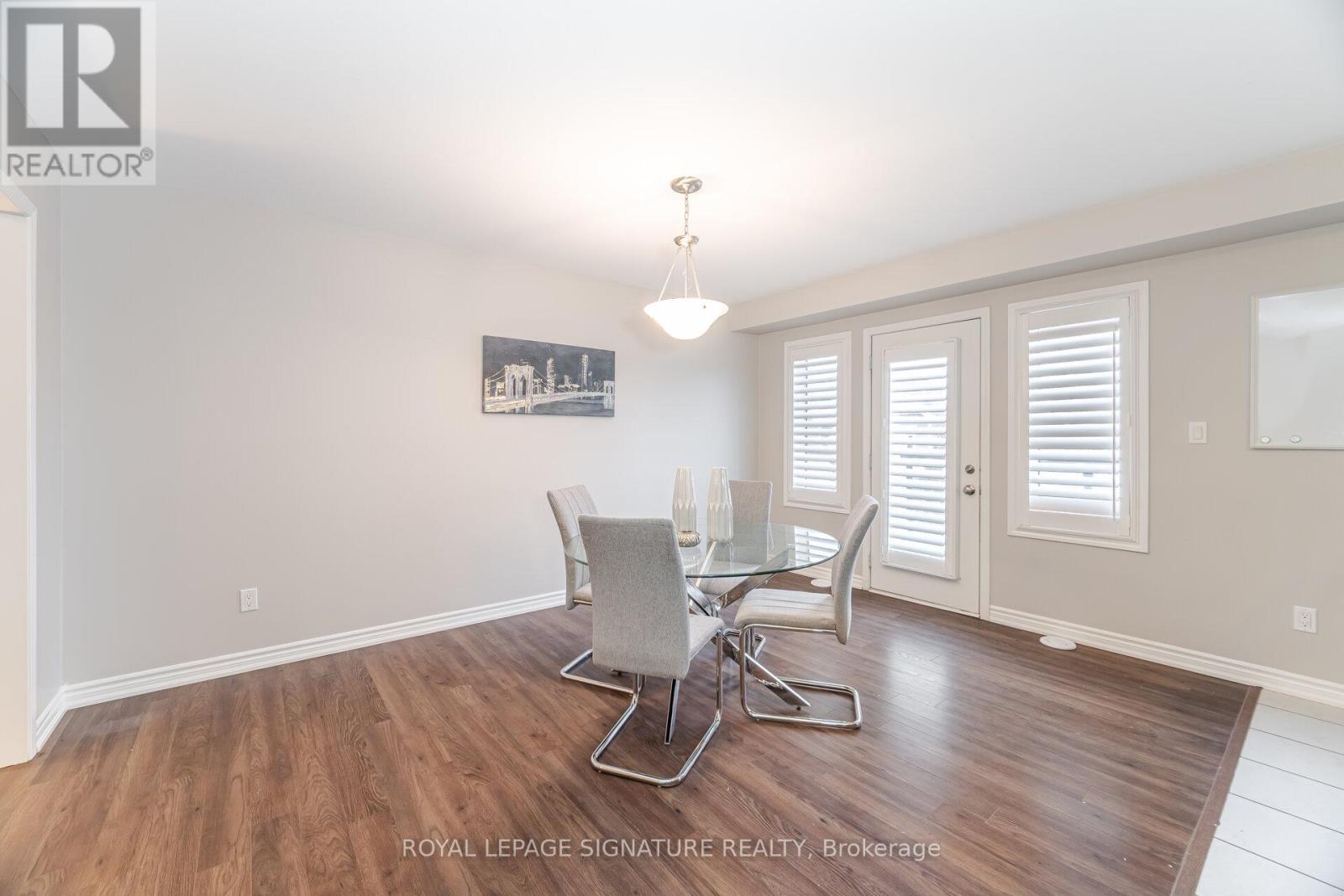 A dining room with a glass table and chairs.