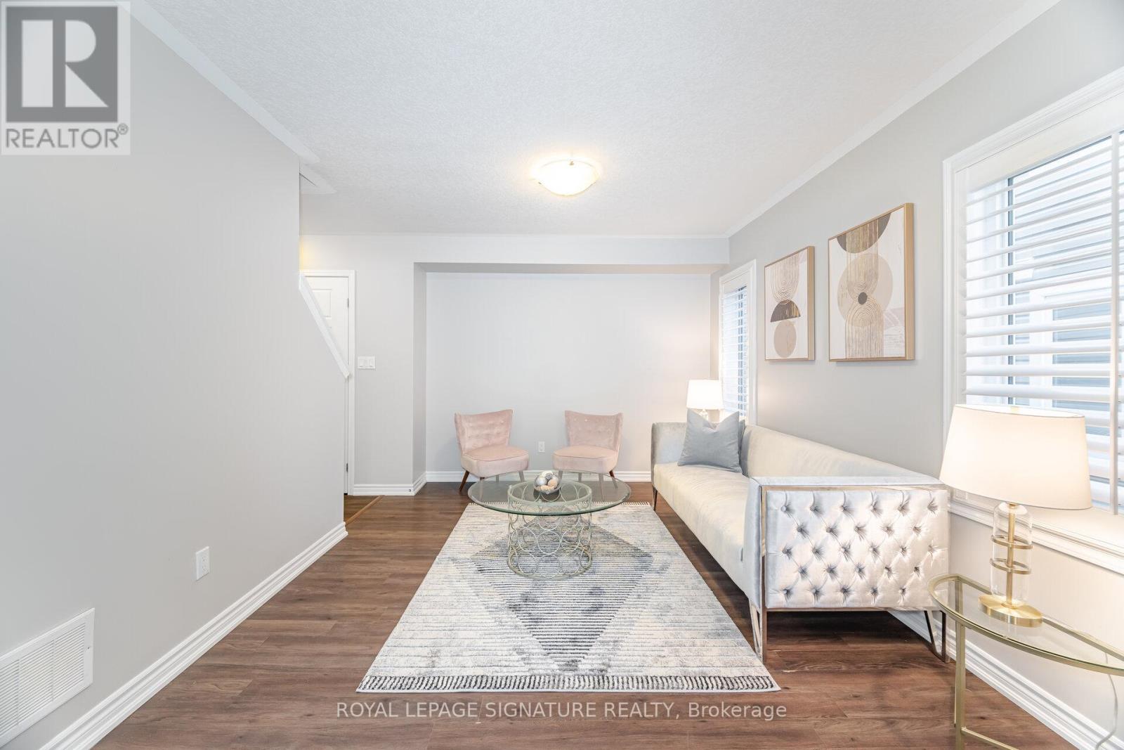 A living room with a white sofa and a coffee table.
