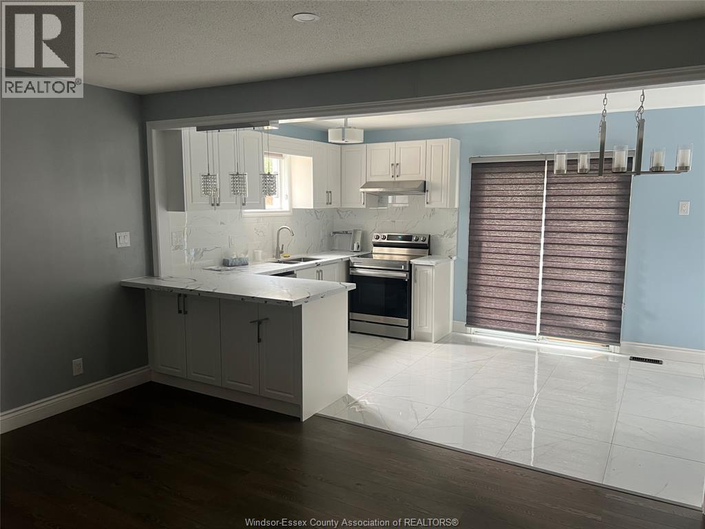 A kitchen with a large island and a stove top oven.