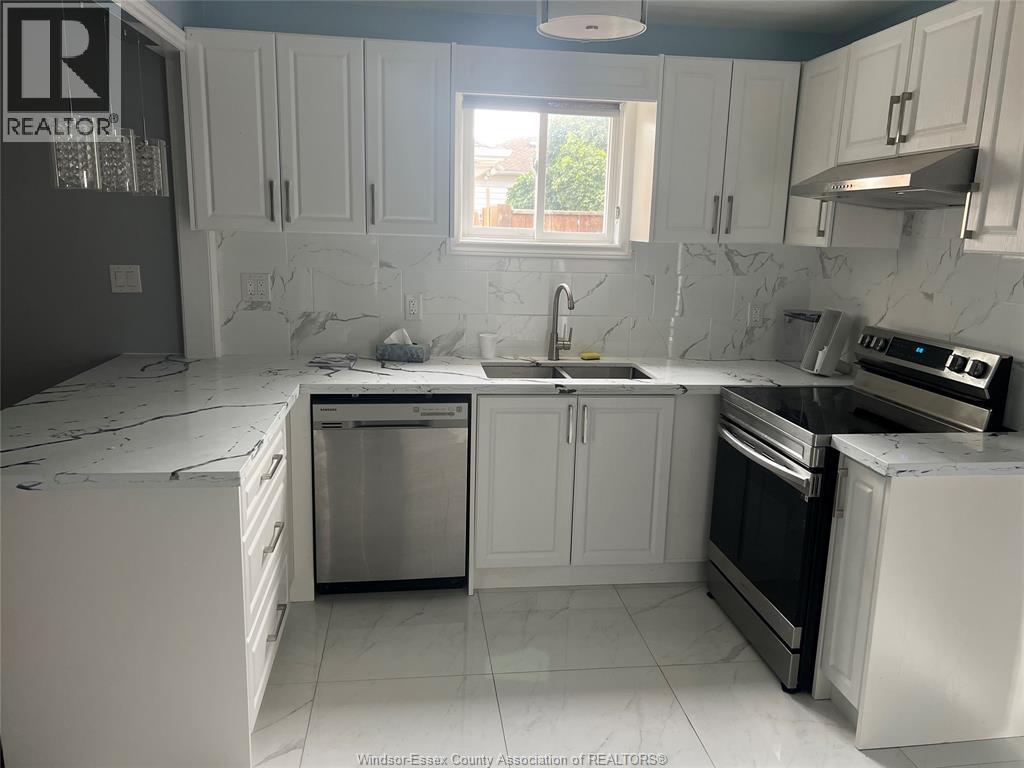 A kitchen with white cabinets and appliances.