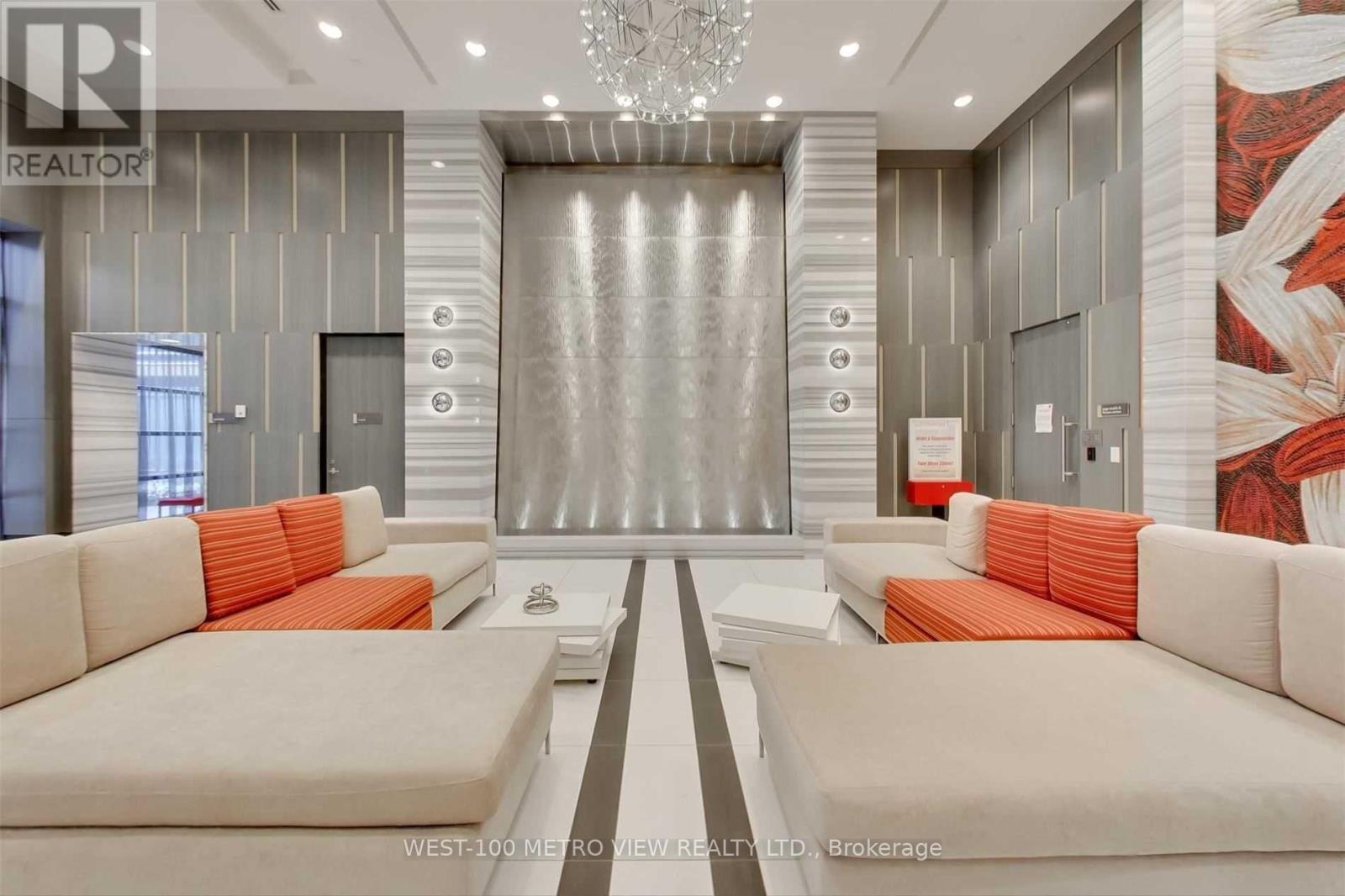 A living room with two couches and a chandelier.