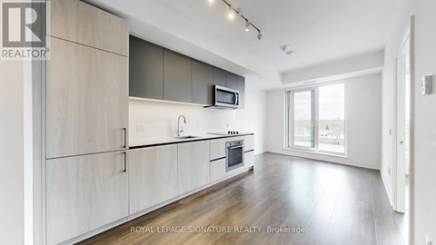 A modern kitchen with wooden cabinets and stainless steel appliances.