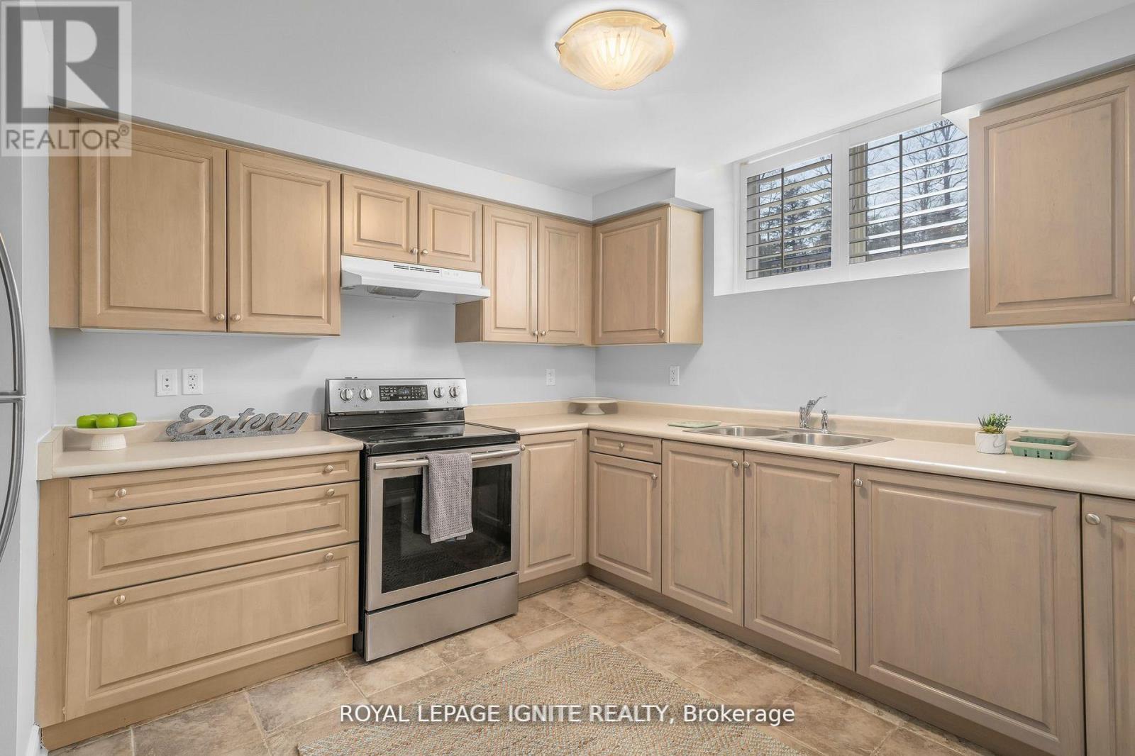 A kitchen with wooden cabinets and a stove top oven.