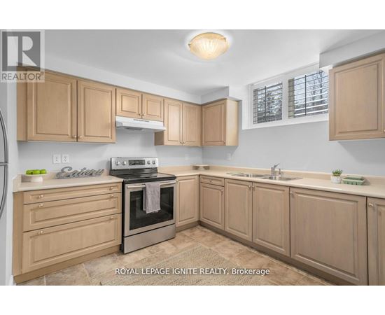 A kitchen with wooden cabinets and a stove top oven.