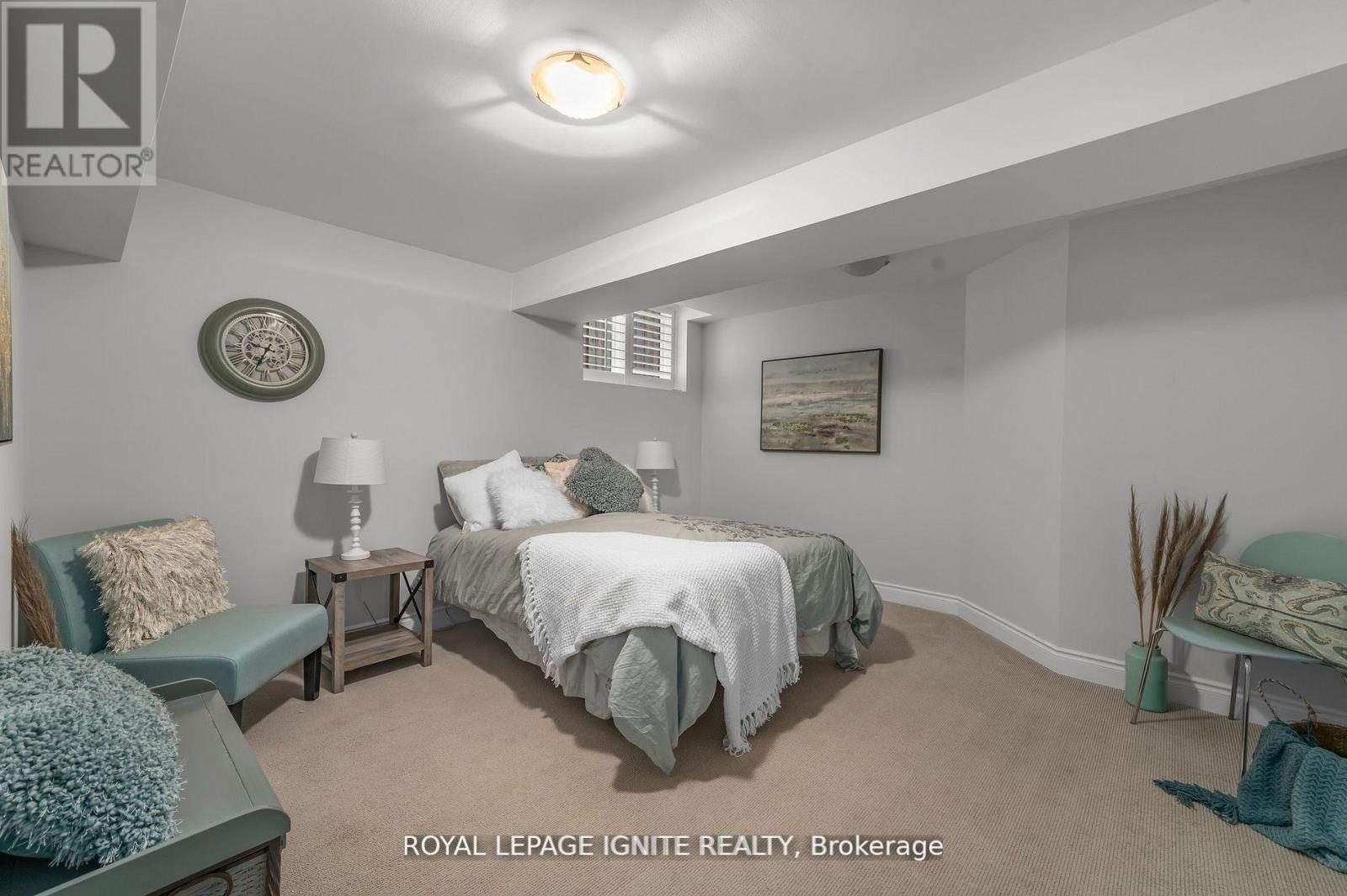 A bedroom with a bed, nightstands, and a chair.