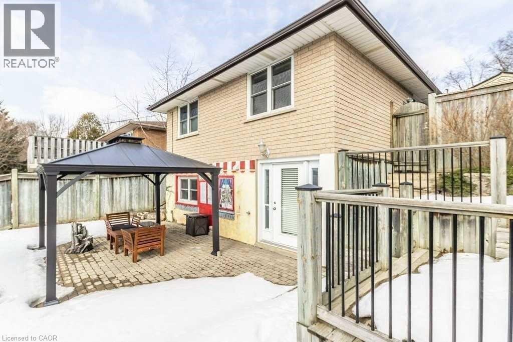 A house with a patio and a gazebo in the snow.