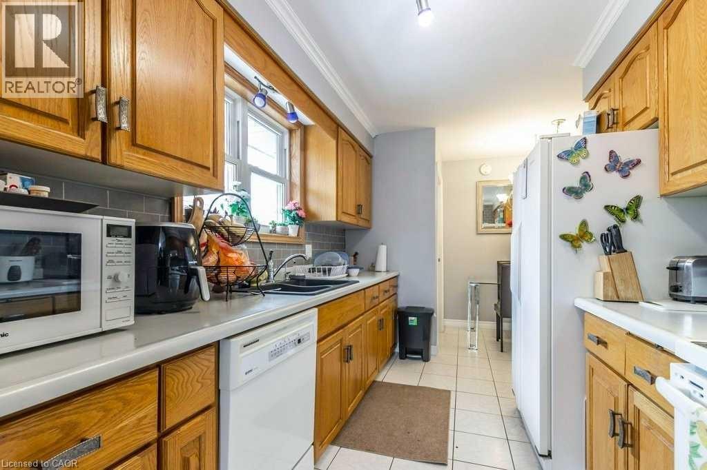 A kitchen with wooden cabinets and a white fridge.