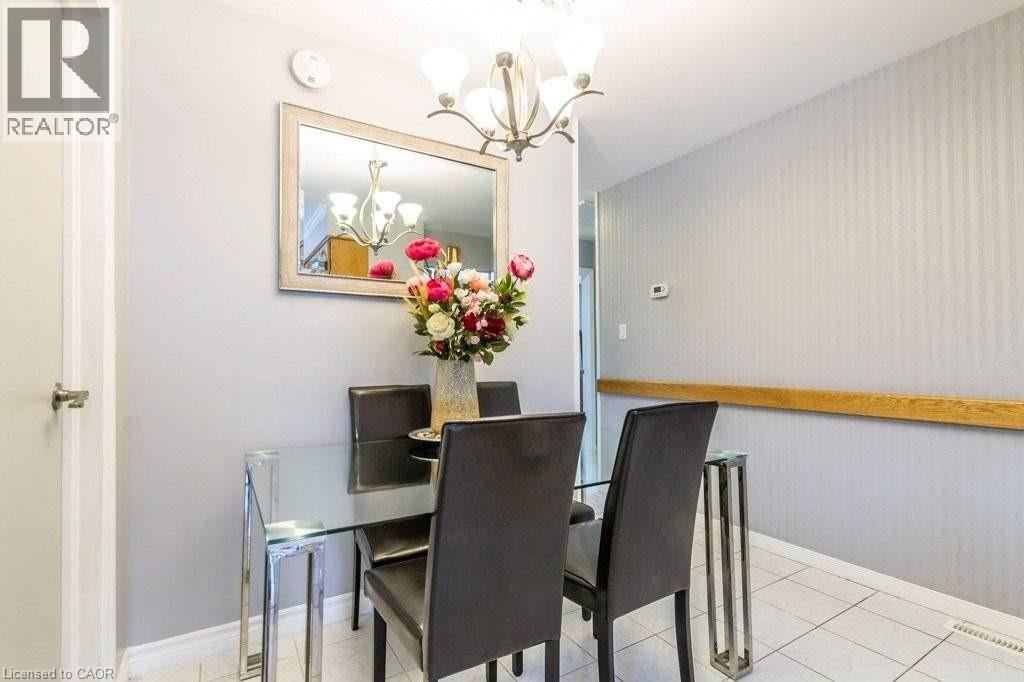 A dining room with a glass table and chairs.