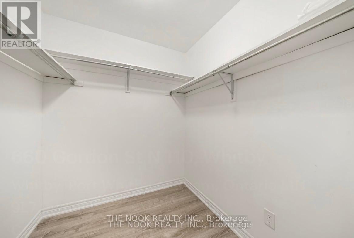 A white interior space with a wood floor and a white ceiling.