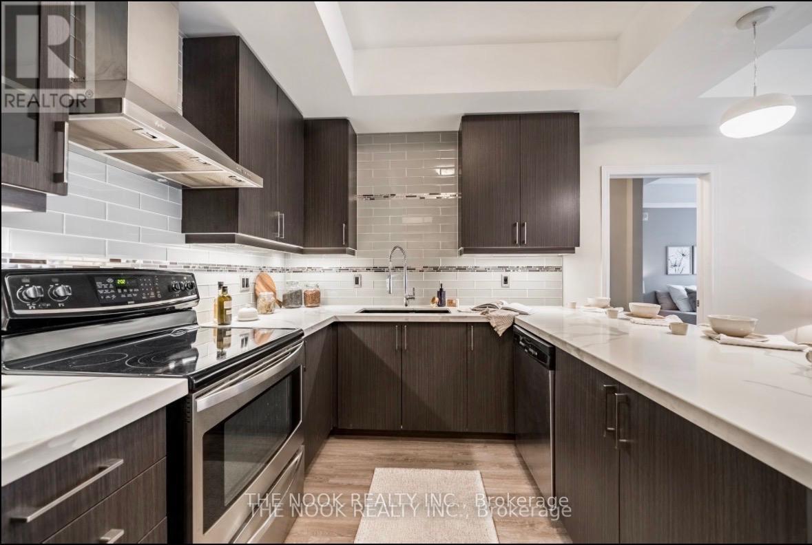 A modern kitchen with dark brown cabinets and stainless steel appliances.