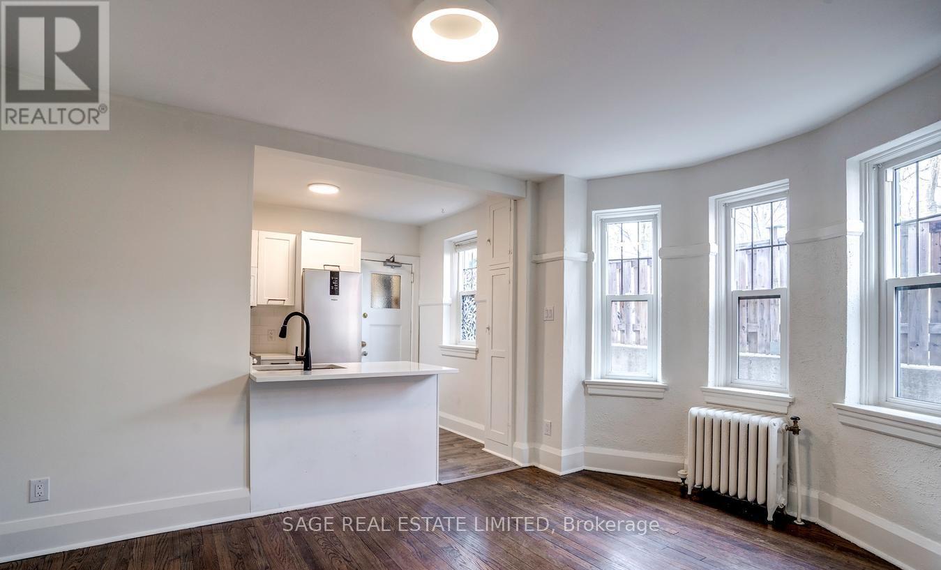 A realtor's office with a white interior and a large window.