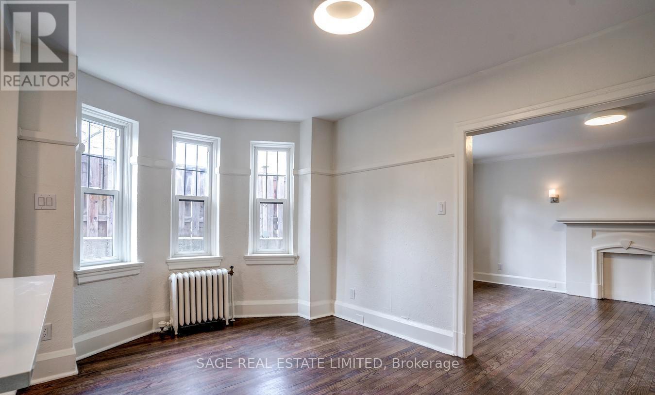 A room with a fireplace and a large window.