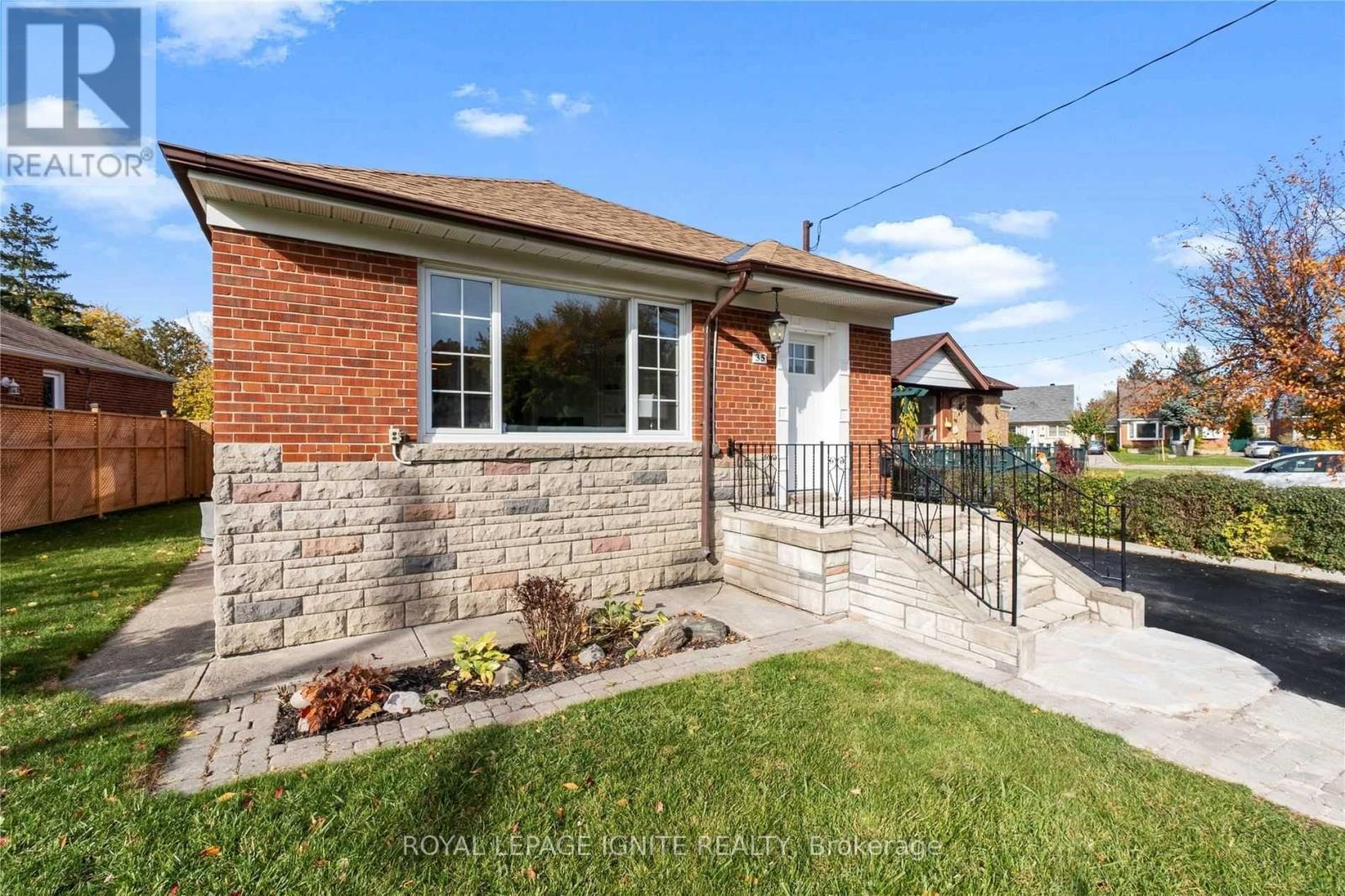 A house with a brick facade and a white door is for sale.