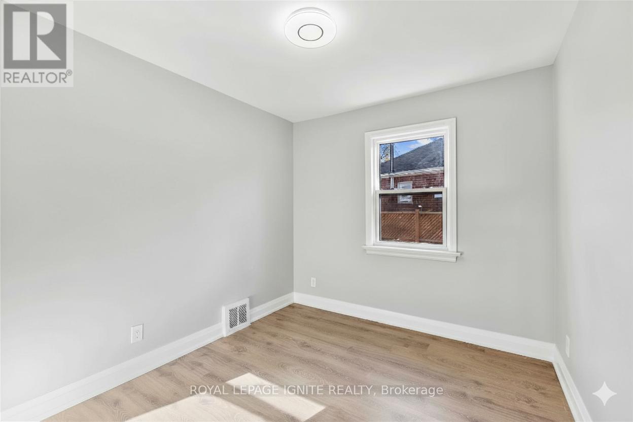 A room with a window and a picture on the wall.