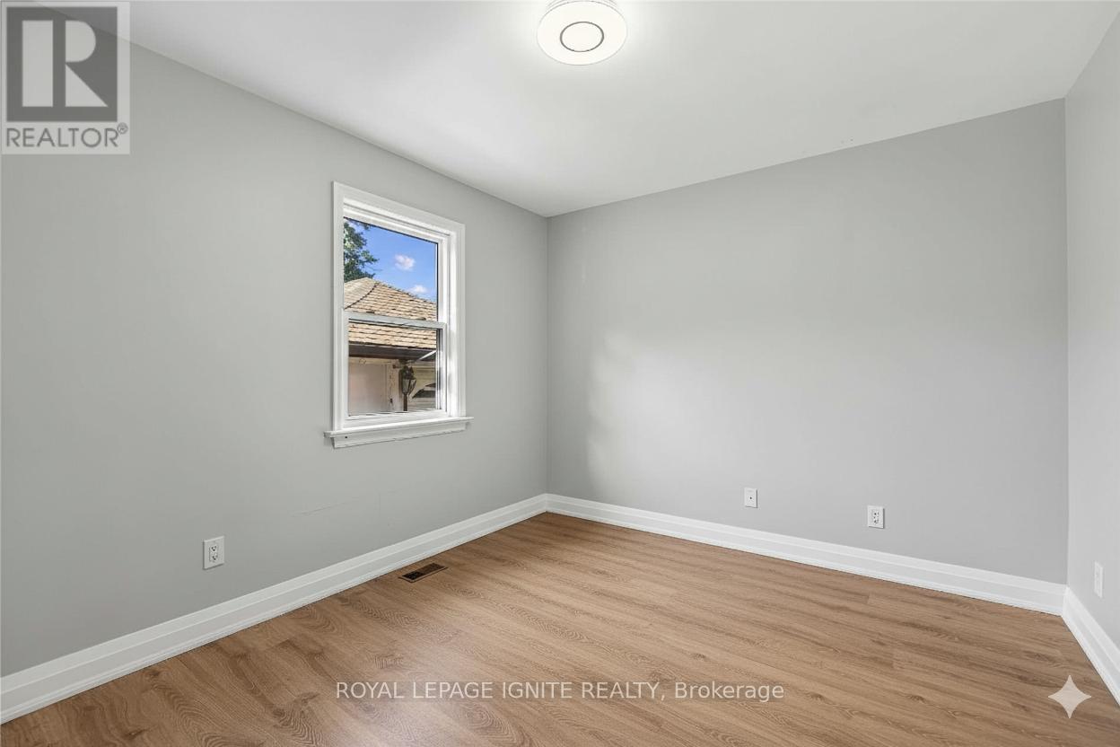 A room with a window showing a house outside.