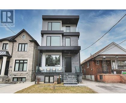 A modern two-story house with a balcony is for sale.