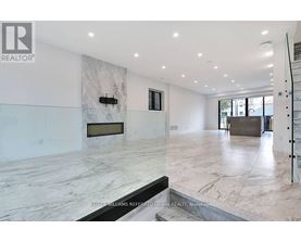 A spacious living room with a marble floor and a fireplace.