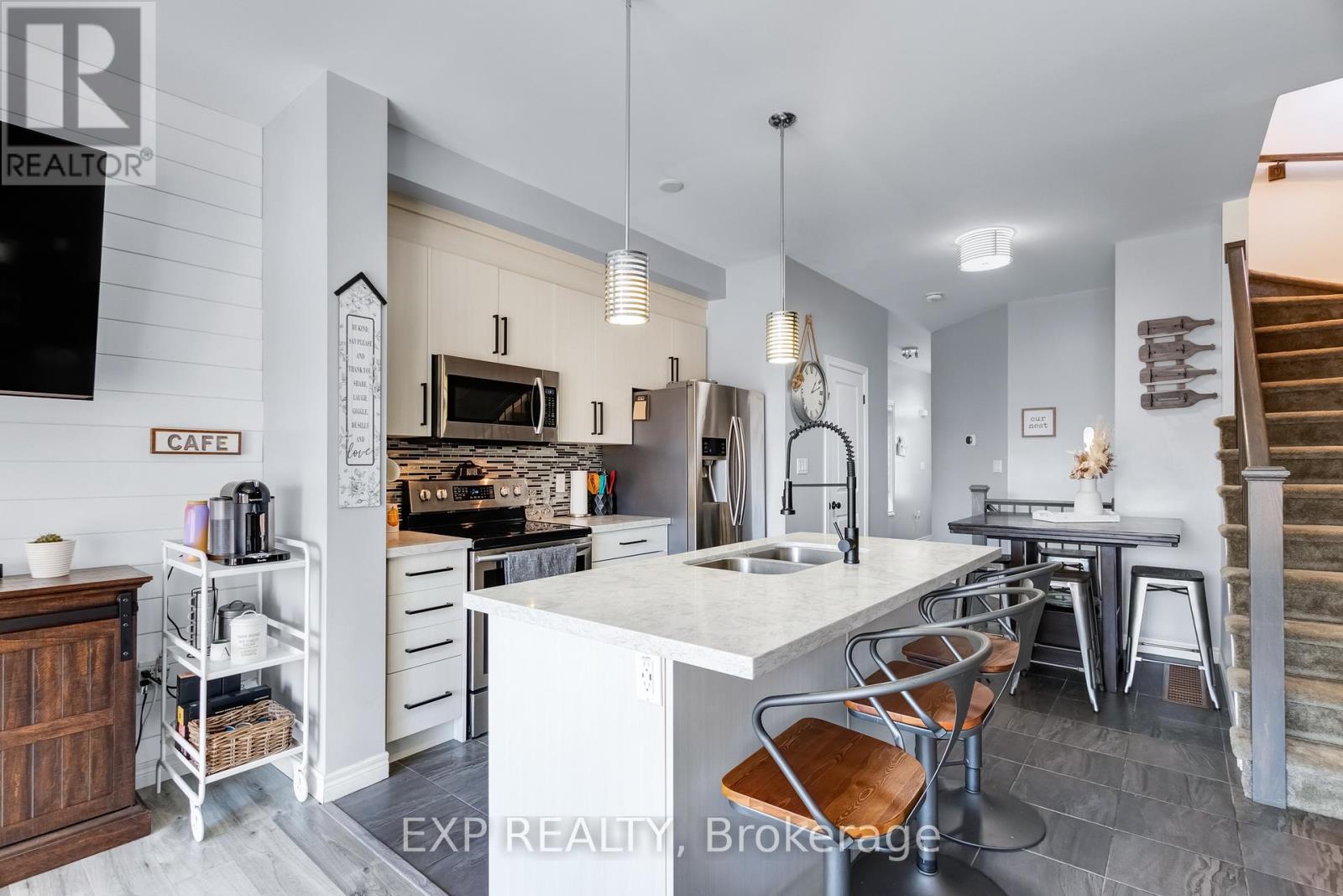 A modern kitchen with white cabinets and a large island.