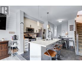 A modern kitchen with white cabinets and a large island.