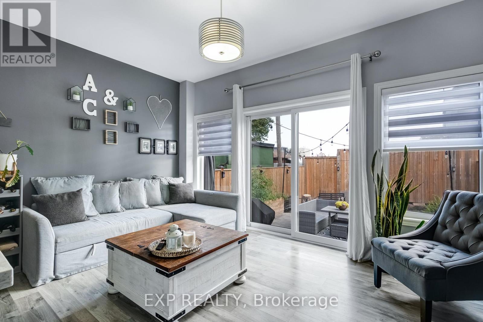 A living room with a grey couch and a coffee table.