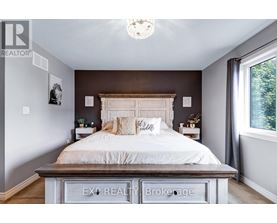 A bedroom with a large bed and a chandelier.