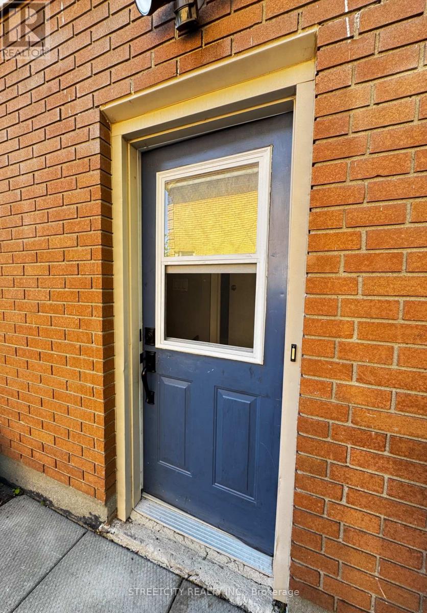 A blue door with a window in the middle of it.