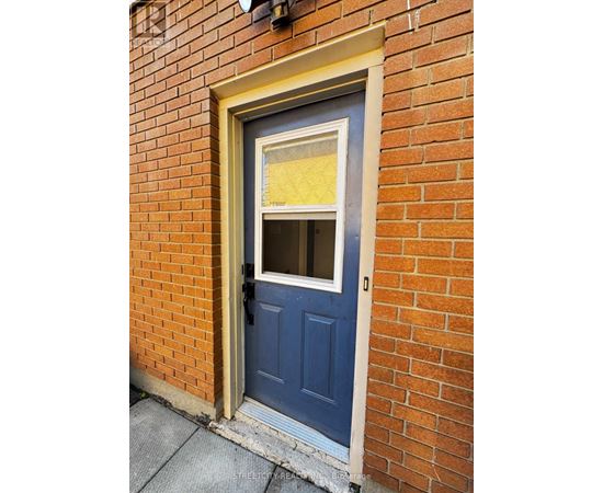 A blue door with a window in the middle of it.