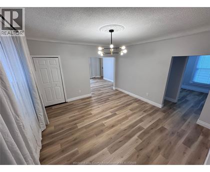A room with wooden flooring and a white door.