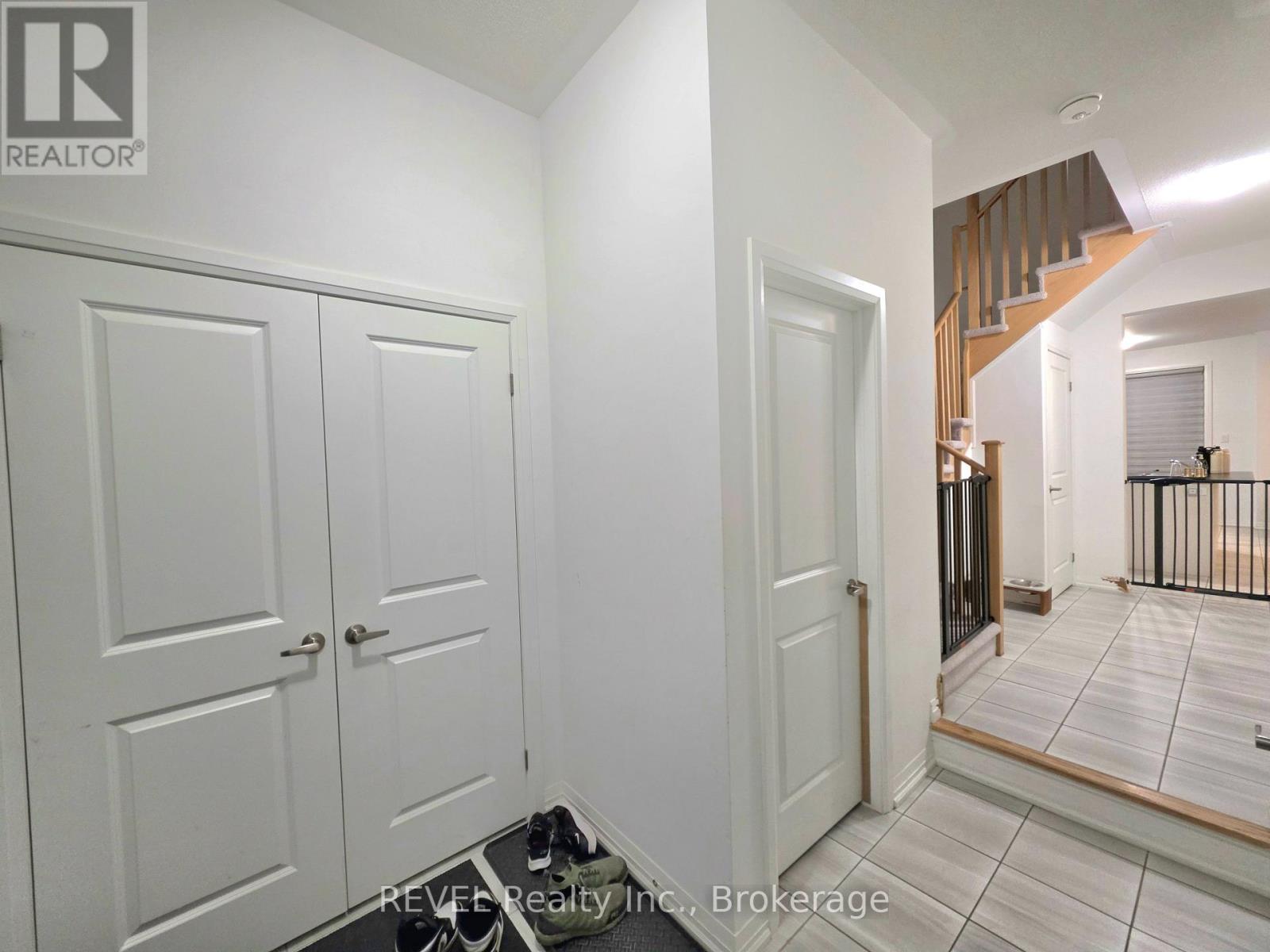 A brokerage sign is on the bottom left of a white door.