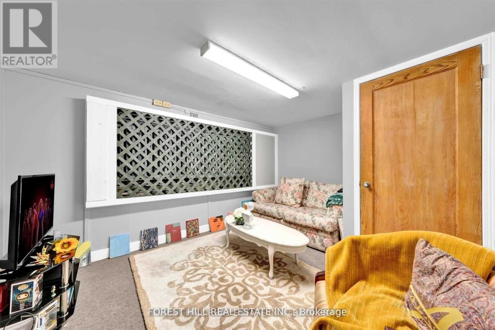 A living room with a white couch and a yellow chair.
