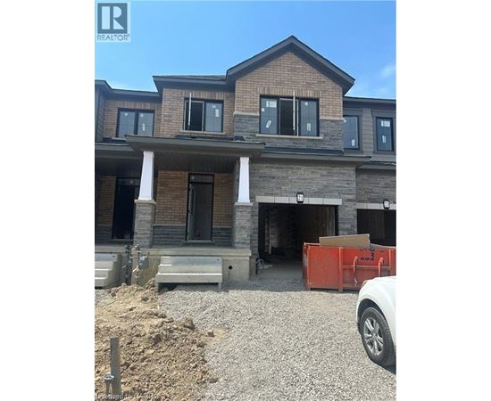 A house under construction with a white car parked in front.