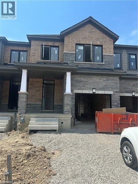 A house under construction with a white car parked in front.