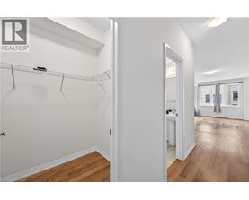 A white bedroom with a walk in closet.