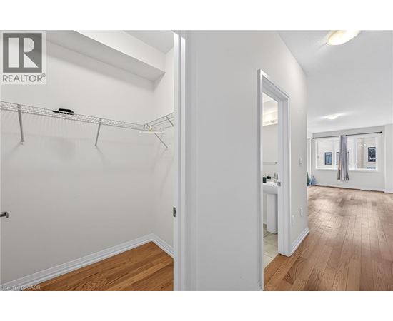 A white bedroom with a walk in closet.