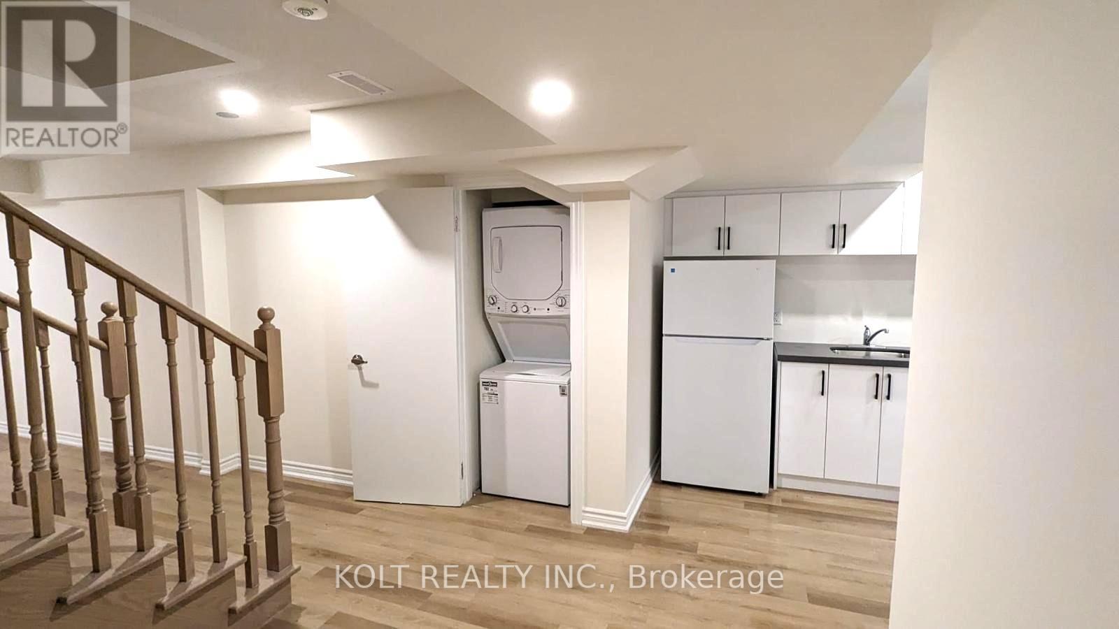 A kitchen area with white appliances and cabinets.