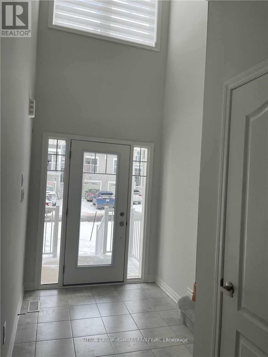 A hallway with a glass door leading to a parking lot.