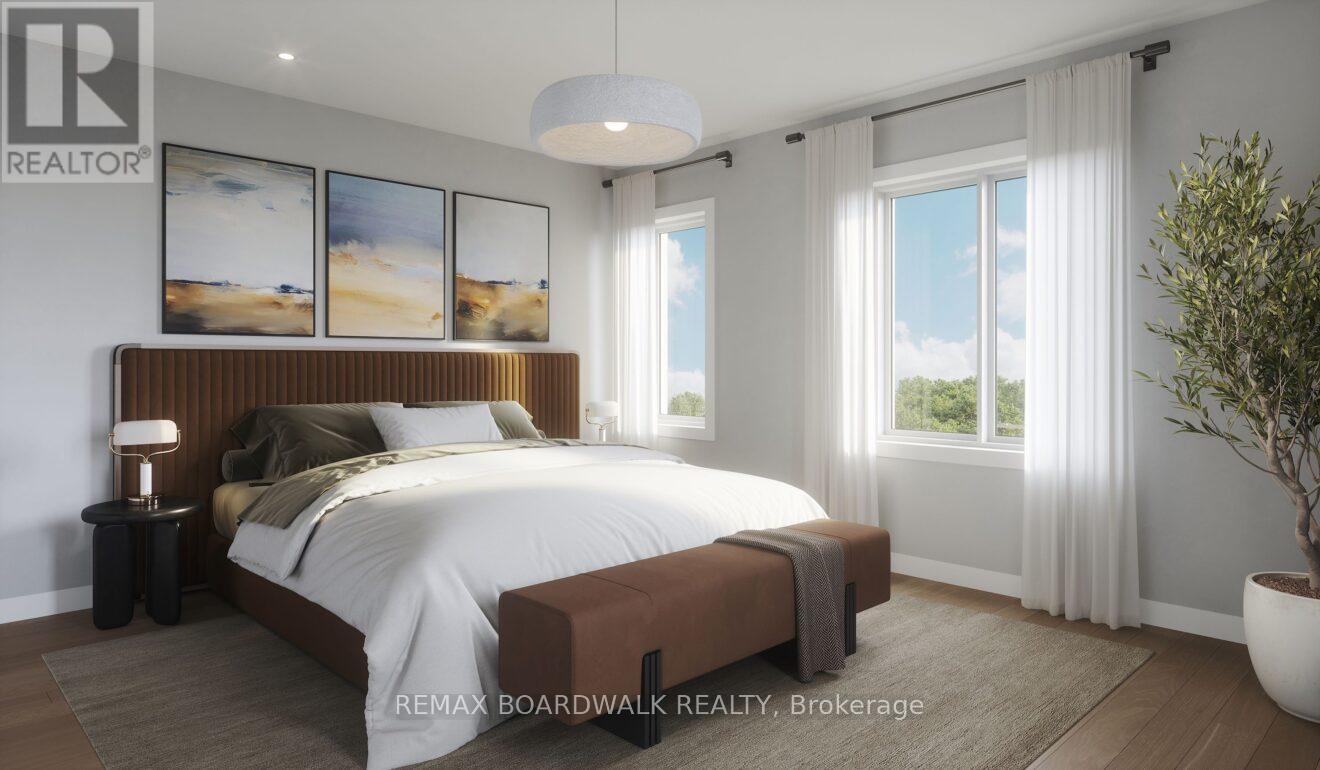 A bedroom with a large bed, a lamp, and a potted plant.