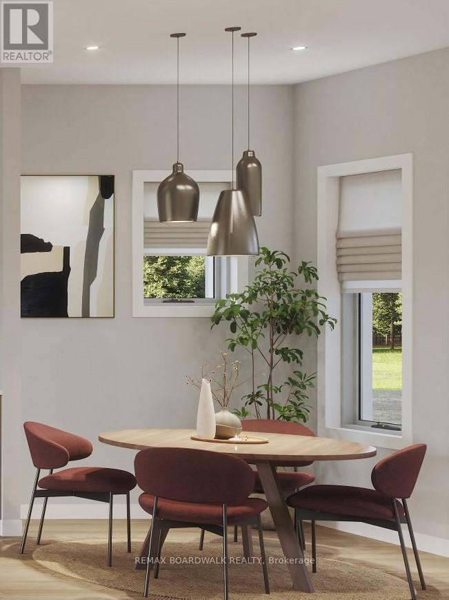 A modern dining room with a round table and chairs.