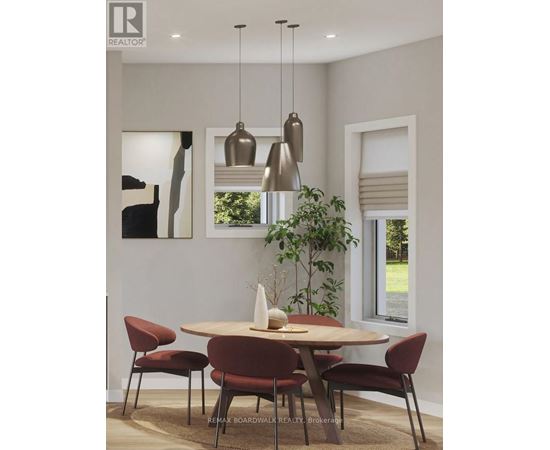 A modern dining room with a round table and chairs.