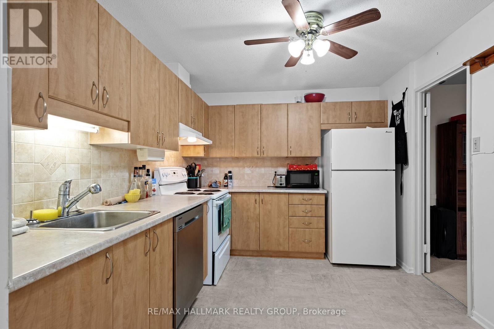 A kitchen with wooden cabinets and a white refrigerator.