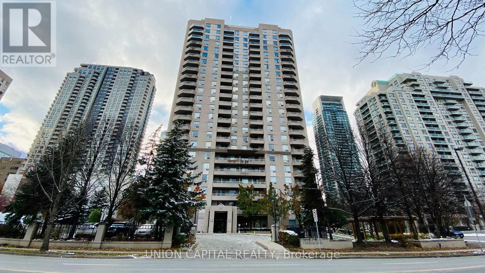 A tall building with a sign that says "REALTOR" in front of it.