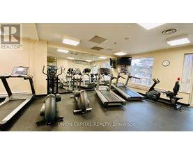 A gym with treadmills, elliptical machines, and other exercise equipment.