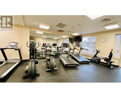 A gym with treadmills, elliptical machines, and other exercise equipment.