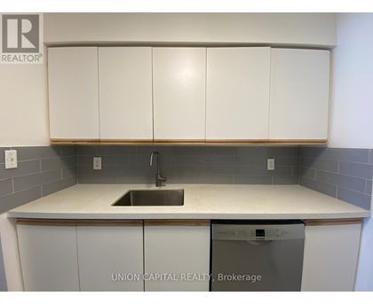 A kitchen with a sink and a dishwasher.
