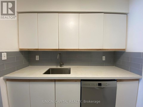 A kitchen with a sink and a dishwasher.