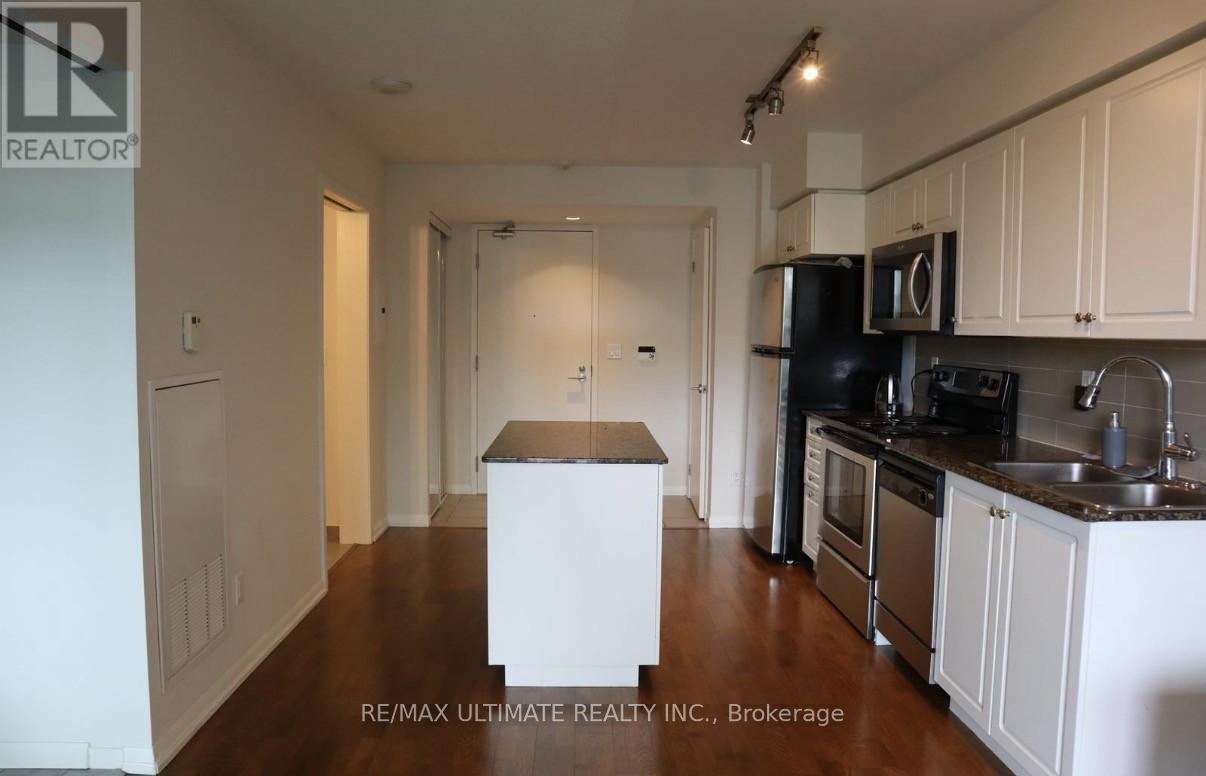 A kitchen with white cabinets and a black stove top oven.