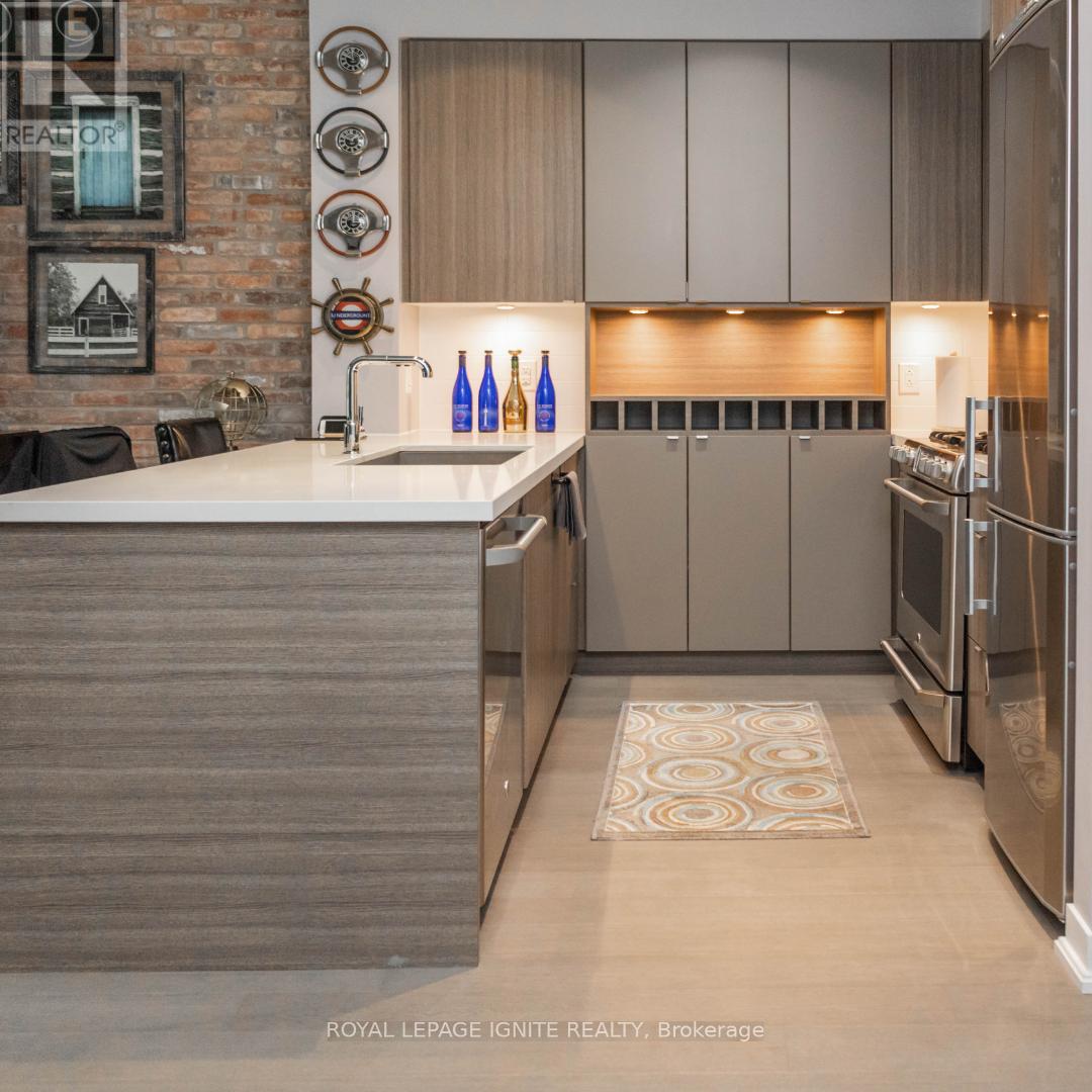 A kitchen with a white counter top and a brick wall.