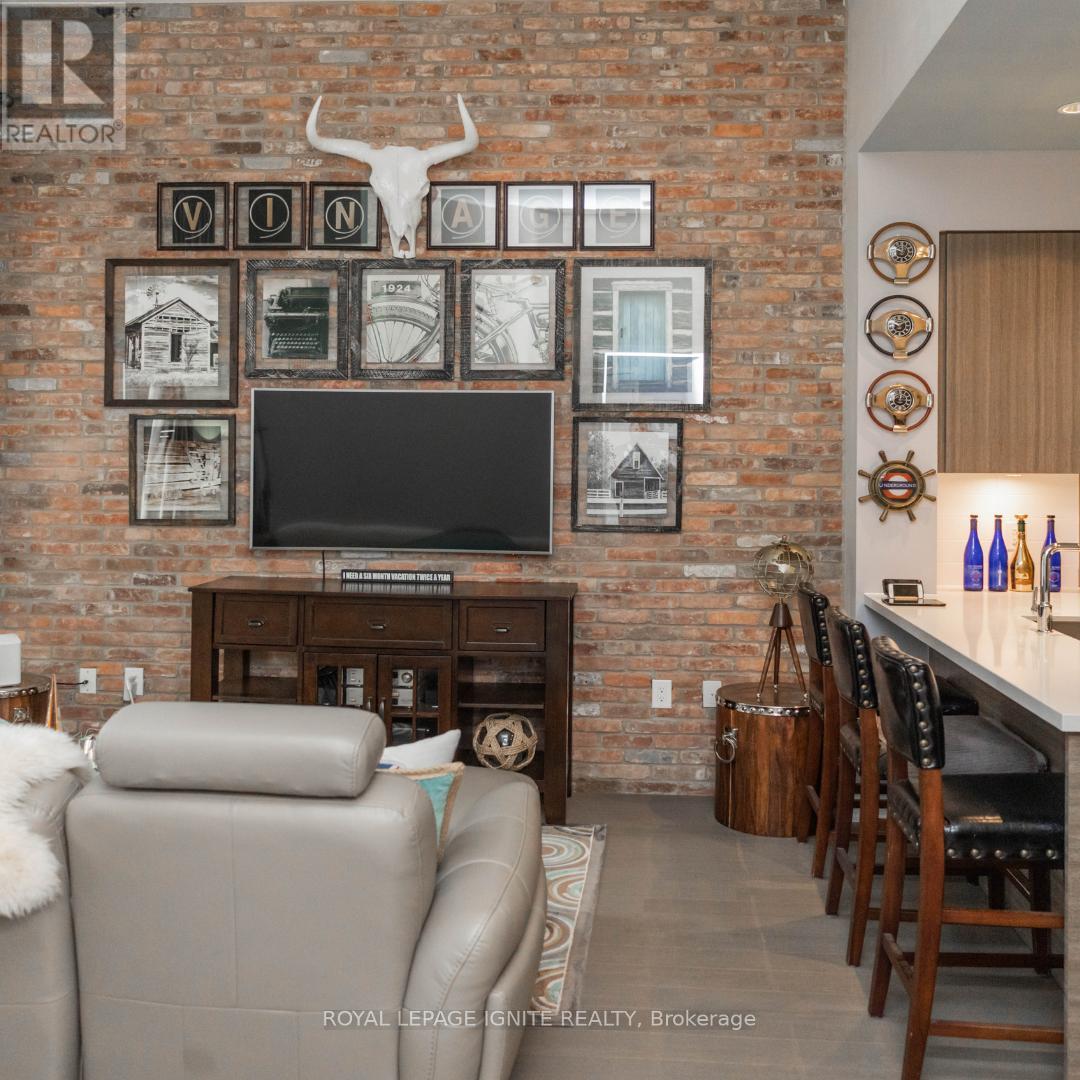 A living room with a brick wall and a flat screen TV.