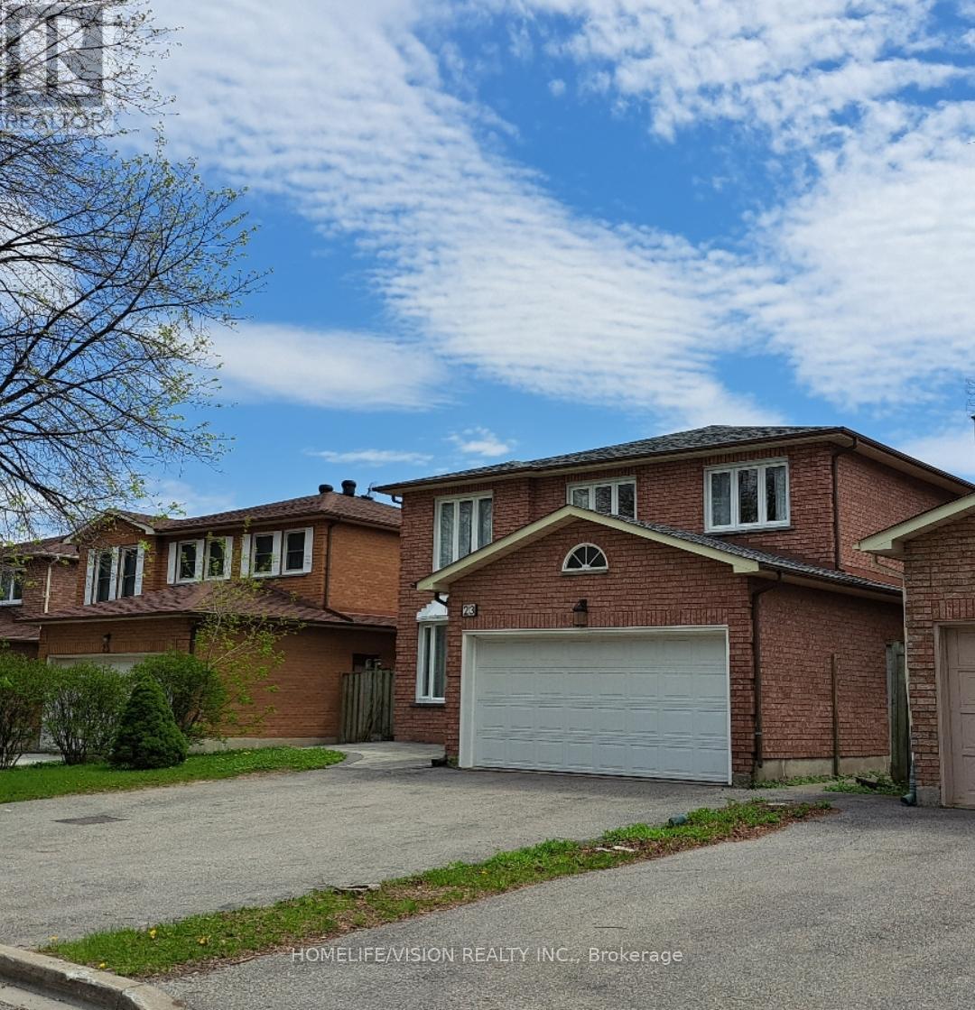 A large brick house with a white garage door in front.